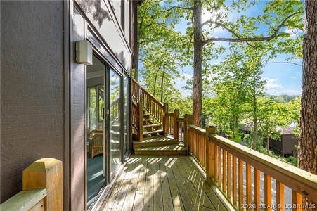 Step onto your private deck and breathe in the fresh air surrounded by tall trees and dappled sunlight, perfect for morning coffee or evening relaxation with nature at your doorstep.