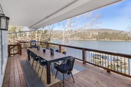 Spacious lakefront deck with stunning water views where you can dine outdoors and soak in peaceful mountain scenery.