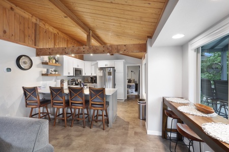 Step into your open-concept retreat where vaulted wood ceilings and modern comforts blend seamlessly. Gather at the breakfast bar, cook in your fully-equipped kitchen, and unwind in a space designed for relaxation and togetherness.