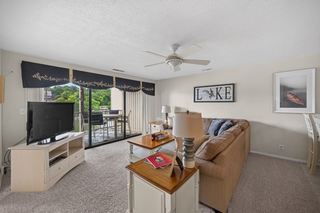 Sink into your cozy couch and unwind with views of the lake right from your living room. The open balcony invites fresh air and relaxation after a day on the water.