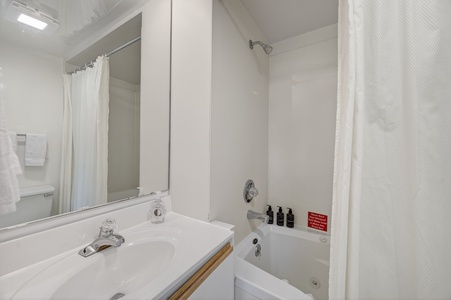 A bright, spotless bathroom awaits your arrival with a full tub-shower combo, fresh towels, and thoughtful amenities—everything you need to unwind and refresh.