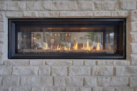 Propane Fireplace that looks into both living room and pool table room