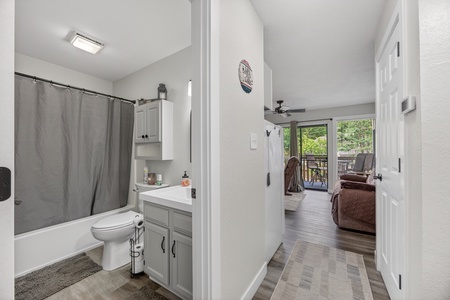 Step through the hallway into your cozy retreat, where natural light spills in from the balcony. Your private bathroom awaits just steps away, complete with fresh linens and a soothing tub.