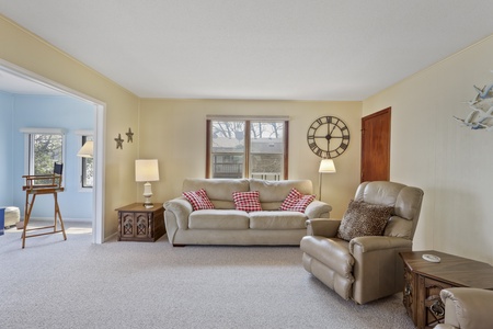 Settle into this cozy living room where soft leather seating and warm lighting create your perfect retreat for relaxation.