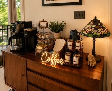 Start your morning right with a thoughtfully curated coffee station, complete with a Keurig, fresh syrups, and all the extras you need for your perfect cup.