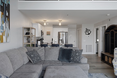 Sink into your plush sectional and feel instantly at home in this bright, coastal-themed space where comfort meets modern style.