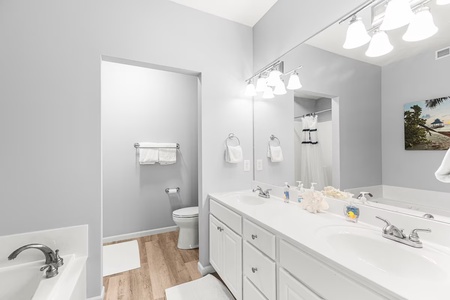 Refresh in your spacious bathroom with dual vanities, soaking tub, and crisp white finishes that create a serene spa-like retreat.