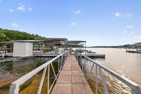 Scenic private boat dock facilities extend over calm lake waters, offering direct access to waterfront adventures and relaxation on sunny afternoons.