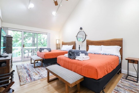 Upstairs bedroom. Two comfortable queen beds with private patio overlooking the lake.