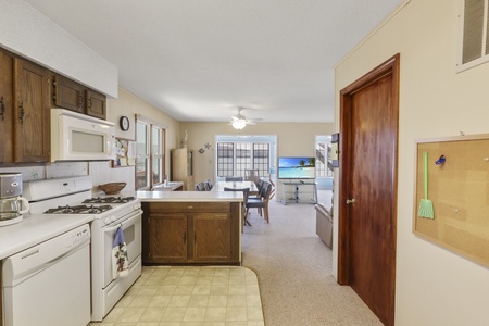 Your fully equipped kitchen flows into the living area, perfect for preparing meals while staying connected with your group.