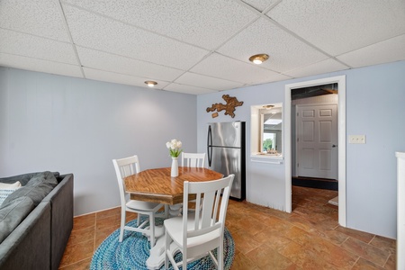 Gather around your own cozy dining table beneath soft lighting, with a modern kitchen just steps away for easy meal prep.