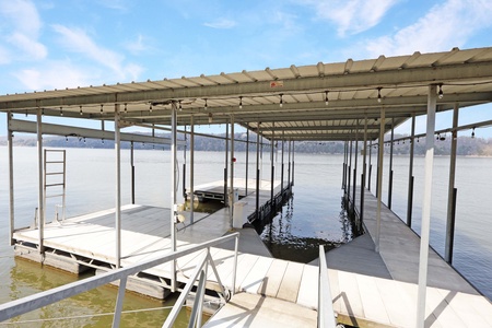 Private lakefront dock with boat lift and covered slip provides direct water access for your aquatic adventures.