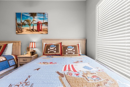 Your little ones will dream of pirate adventures in this whimsical bedroom with skull-and-crossbones pillows and charming nautical decor.