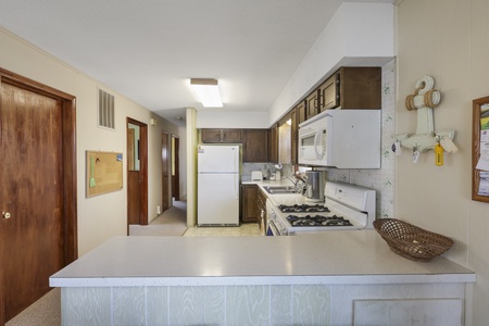 Your fully equipped kitchen awaits with generous counter space, modern appliances, and everything needed to prepare memorable meals during your stay.