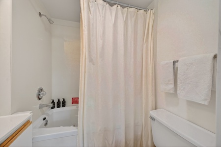Your private bathroom is bright and clean, featuring a full tub-shower combo with fresh towels and complimentary toiletries ready for your arrival.