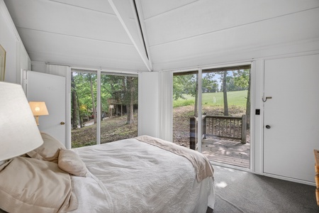 Wake up to peaceful views of lush greenery and natural landscapes framed by floor-to-ceiling windows in your private bedroom retreat.