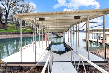 Private boat dock with covered slip provides easy lake access for water adventures and peaceful moments on the water.