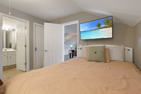 Unwind in your peaceful bedroom featuring a wall-mounted TV and ensuite bathroom for ultimate convenience and comfort.