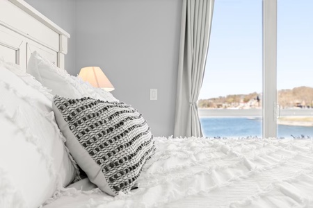 Wake up to stunning water views from your cozy bedroom, where soft linens and gentle morning light create the perfect start to your day.