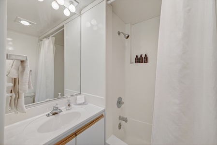 Freshen up in your bright, clean bathroom with a spacious shower-tub combo, plush towels, and curated toiletries ready for you.