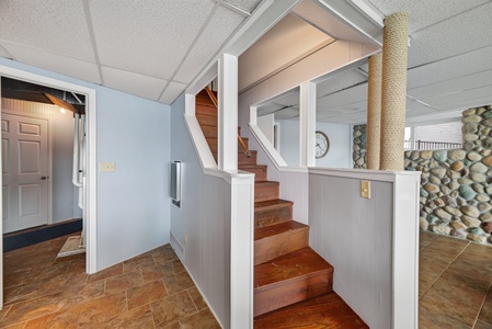 Step inside to discover a welcoming entry with beautiful wood-toned flooring, a unique rope-wrapped accent pillar, and charming stone feature walls that add character to your home away from home.