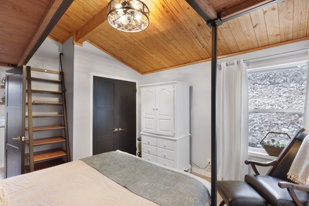 Unwind beneath vaulted wood ceilings in your serene bedroom retreat, where natural light and thoughtful touches create a cozy mountain escape just for you.