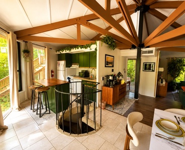 Step into your open-concept retreat with soaring wood beams, a stylish kitchen with modern appliances, and natural light streaming through large windows. Unwind in this cozy yet spacious sanctuary where rustic charm meets comfort.