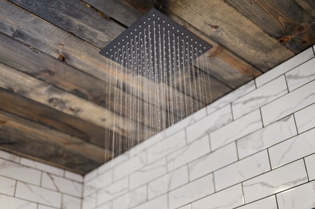 Rainfall shower head in the spacious walk-in shower