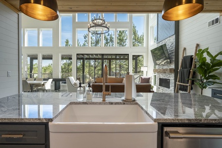 Kitchen receives plentiful natural light from the living space's floor-to-ceiling windows