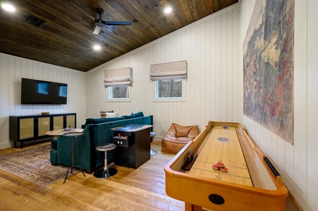 Game room with shuffleboard, arcade, and Smart HDTV
