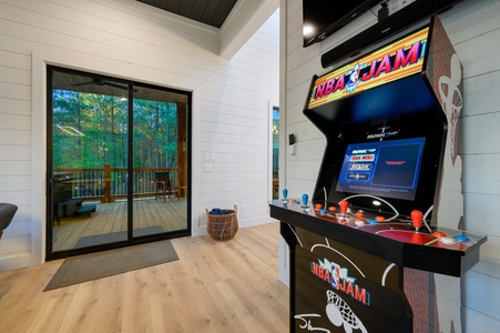 Game room with arcade, card table, darts, and air hockey