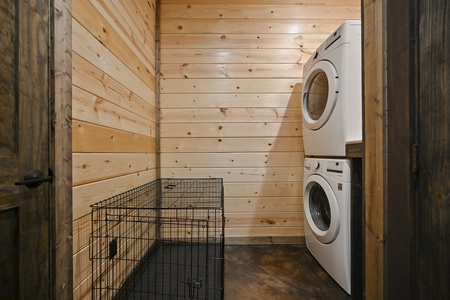 Laundry closet with large dog crate provided