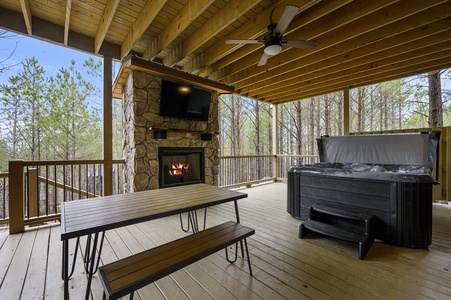 Outdoor dining, hot tub, gas grill, gas fireplace, and TV are found on the lower deck