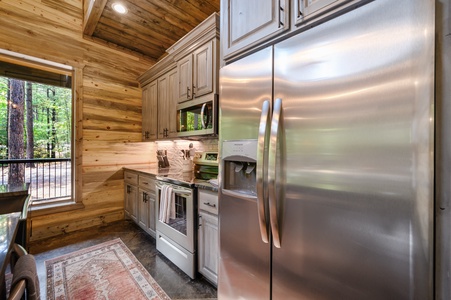 Stainless steel appliances and fully stocked kitchen