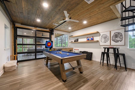 Game room with pool table and retractable garage door