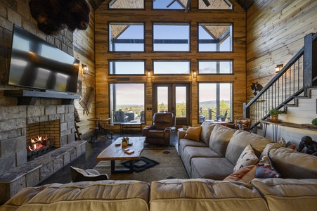 Spacious living area with floor-to-ceiling windows and mountain views