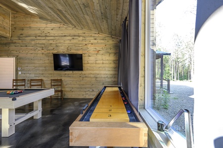 Game room with pool table, shuffleboard, and Smart TV