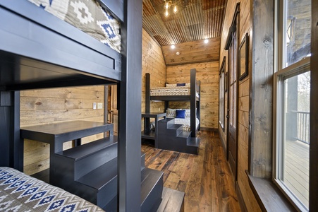 Upstairs bunk room has 4 queen beds sleeping 8 guests