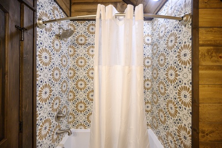 Full bathroom upstairs with tub/shower combo services the bunk and game rooms