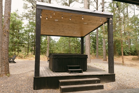 Covered hot tub allows for enjoying in all weather