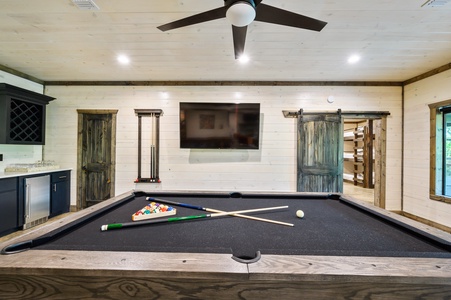 Downstairs game room with full-size pool table and Smart TV