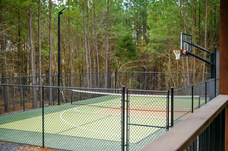 Private fenced pickleball and basketball court