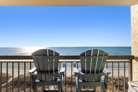 Relax in Adirondack chairs on your private balcony overlooking pristine beachfront waters.