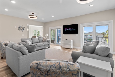The living room is expansive and offers plenty of space to relax and take a peak at the beach right across the street!