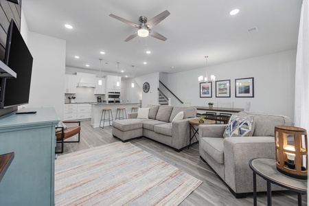 This home features a spacious living area, dining space, modern chefs kitchen, and back patio.
