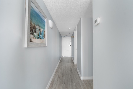 Your bright, welcoming hallway leads you through the thoughtfully designed space with coastal artwork setting a peaceful tone.