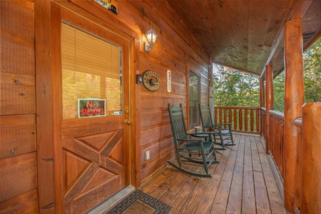 Rocking chairs on a covered deck at Firefly Ridge, a 2 bedroom cabin rental located in Pigeon Forge