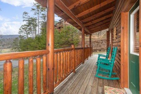 Covered front porch with rocking chairs at Let the Good Times Roll, a 2 bedroom cabin rental located in Pigeon Forge