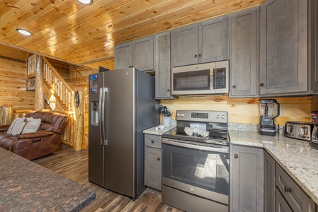 Kitchen with stainless appliances and granite counters at Everly's Splash, a 4 bedroom cabin rental located in Pigeon Forge