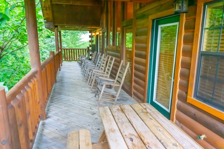 Row of rocking chairs on the deck at Family Ties Lodge
